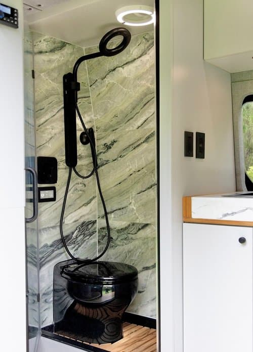 Custom War Horse van shower with stone wall and black fixtures